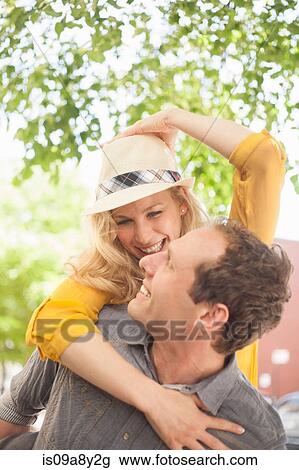 Woman riding piggyback on man View Large Photo Image Stock Image - Woman riding piggyback on man. Fotosearch