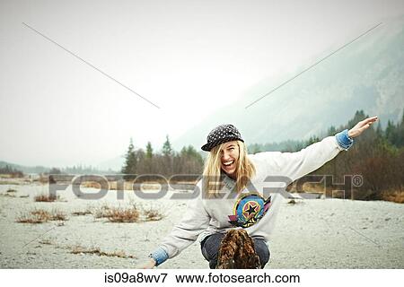 Woman sitting on ground in mountains, laughing View Large Photo Image Stock Photo - Woman sitting on ground in mountains, laughing. Fotosearch