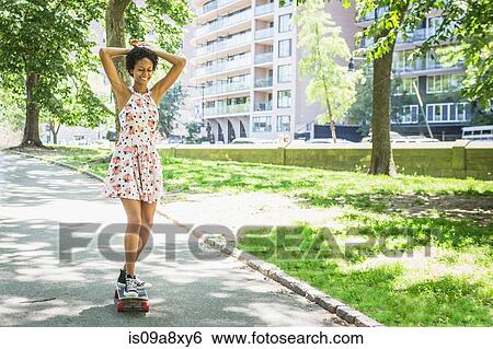Stock Photograph - Woman skateboarding. Fotosearch
