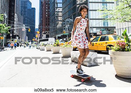 Stock Photography - Woman skateboarding. Fotosearch