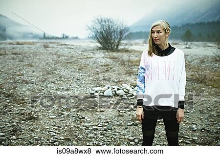 Stock Photo - Woman standing in remote setting. Fotosearch