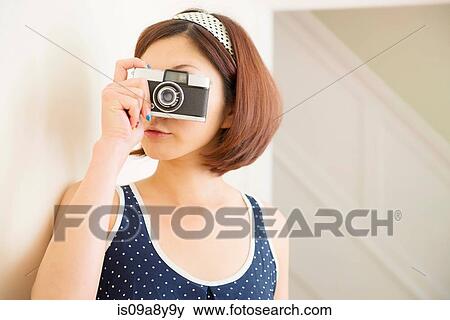 Stock Photo - Woman taking photograph. Fotosearch
