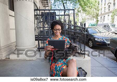 Stock Photo - Woman using digital tablet. Fotosearch