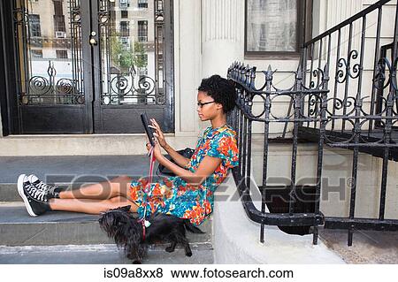 Stock Photo - Woman using digital tablet. Fotosearch
