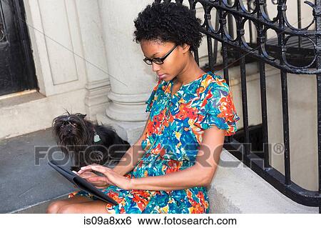 Stock Photograph - Woman using digital tablet. Fotosearch