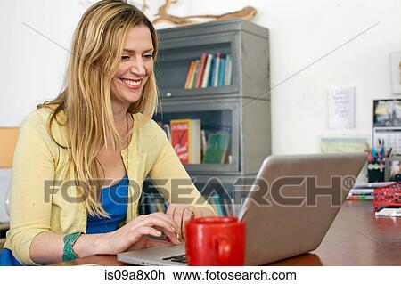 Woman using laptop computer View Large Photo Image Stock Image - Woman using laptop computer. Fotosearch