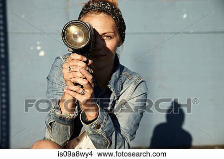 Woman using old video camera View Large Photo Image Picture - Woman using old video camera. Fotosearch