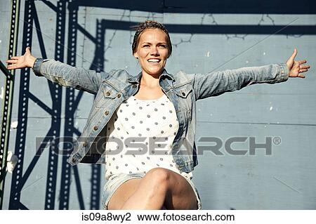 Stock Image - Woman with arms stretched open. Fotosearch