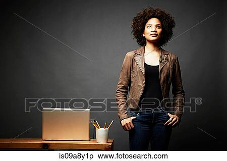 Woman with hands in pocket looking upward View Large Photo Image Stock Photography - Woman with hands in pocket looking upward. Fotosearch