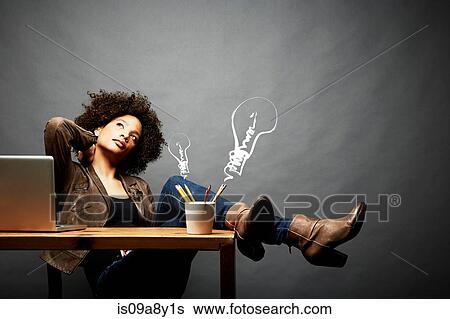 Woman with legs on table searching for ideas View Large Photo Image Stock Photograph - Woman with legs on table searching for ideas. Fotosearch