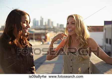 Stock Photo - Women chatting on bridge. Fotosearch