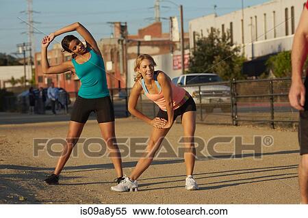Stock Photography - Women doing stretching exercise. Fotosearch