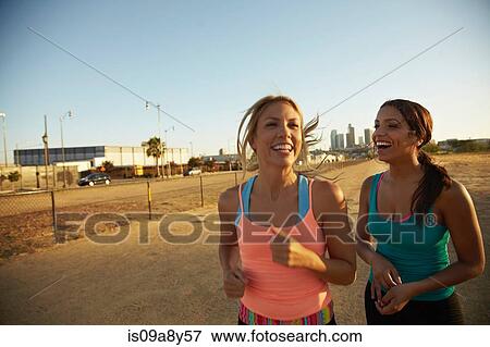 Women jogging and laughing View Large Photo Image Stock Photo - Women jogging and laughing. Fotosearch