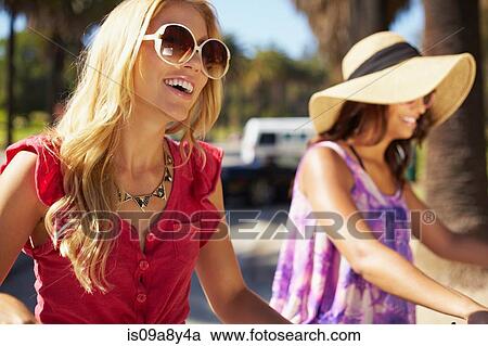 Women on bicycle laughing View Large Photo Image Stock Image - Women on bicycle laughing. Fotosearch