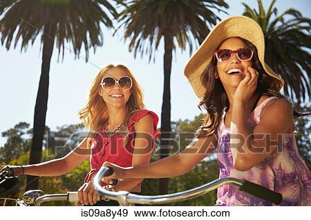 Women on bicycle laughing View Large Photo Image Stock Photo - Women on bicycle laughing. Fotosearch