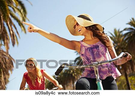 Women riding bicycle View Large Photo Image Stock Image - Women riding bicycle. Fotosearch