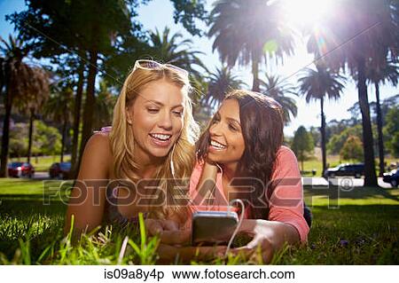 Women sharing text message on phone View Large Photo Image Stock Photography - Women sharing text message on phone. Fotosearch