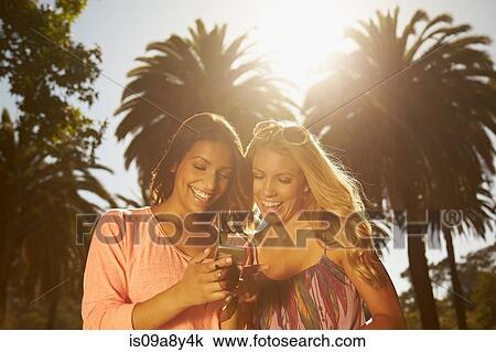 Women sharing text messages on phone View Large Photo Image Stock Image - Women sharing text messages on phone. Fotosearch