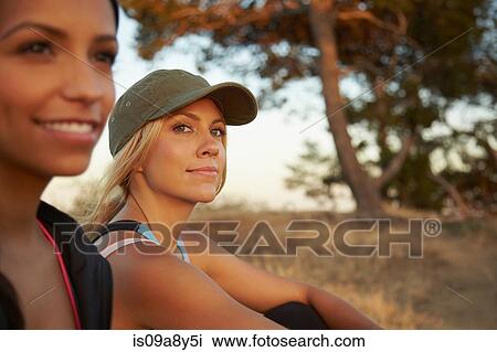 Women sitting on grass View Large Photo Image Stock Image - Women sitting on grass. Fotosearch