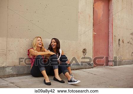 Women sitting on ground laughing View Large Photo Image Stock Image - Women sitting on ground laughing. Fotosearch