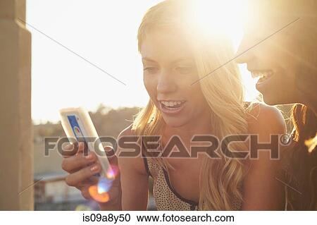 Women using mobile phone View Large Photo Image Stock Image - Women using mobile phone. Fotosearch