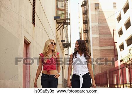 Women walking and chatting on street View Large Photo Image Stock Photo - Women walking and chatting on street. Fotosearch