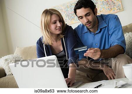 Young couple shopping online with credit card View Large Photo Image Stock Image - Young couple shopping online with credit card. Fotosearch