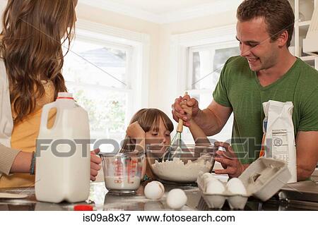 Young girl baking with older brother and sister View Large Photo Image Stock Photo - Young girl baking with older brother and sister. Fotosearch