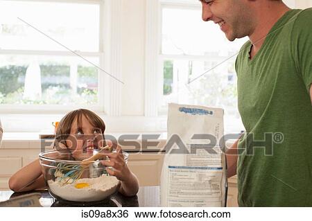 Young girl baking with older brother View Large Photo Image Stock Photograph - Young girl baking with older brother. Fotosearch