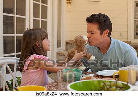 Young girl holding teddy bear for father to kiss View Large Photo Image Picture - Young girl holding teddy bear for father to kiss. Fotosearch
