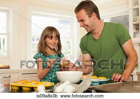 Young girl with older brother icing cupcakes View Large Photo Image Stock Image - Young girl with older brother icing cupcakes. Fotosearch