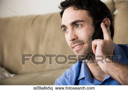 Young man on cell phone View Large Photo Image Stock Photography - Young man on cell phone. Fotosearch