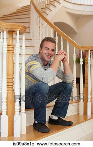 Young man sitting on stairs View Large Photo Image Stock Photography - Young man sitting on stairs. Fotosearch