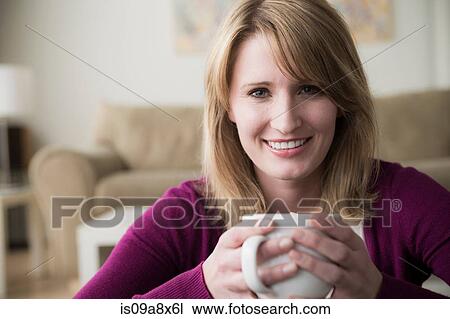 Young woman holding coffee View Large Photo Image Stock Image - Young woman holding coffee. Fotosearch