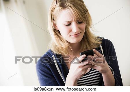 Young woman using cell phone View Large Photo Image Picture - Young woman using cell phone. Fotosearch