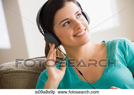 Stock Photography - Young woman wearing headphones. Fotosearch