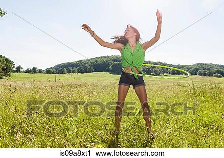 Young woman with plastic hoop View Large Photo Image Stock Image - Young woman with plastic hoop. Fotosearch