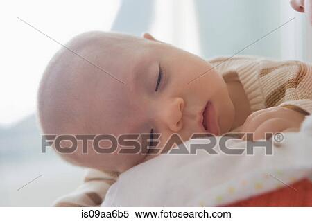 Baby boy sleeping on mother's shoulder, close up View Large Photo Image Stock Photography - Baby boy sleeping on mother's shoulder, close up. Fotosearch