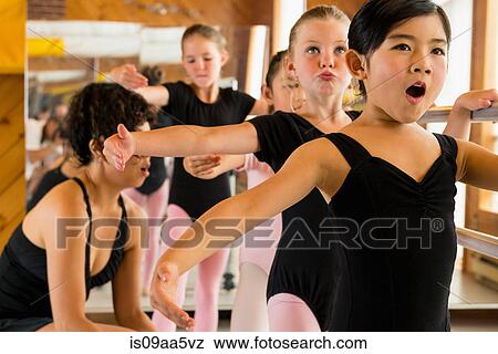 Ballerinas practising at the barre in ballet school View Large Photo Image Stock Photo - Ballerinas practising at the barre in ballet school. Fotosearch