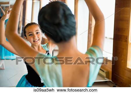 Stock Image - Ballerinas practising in dance studio. Fotosearch