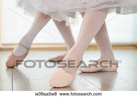 Ballerinas practising together, low section View Large Photo Image Stock Photo - Ballerinas practising together, low section. Fotosearch