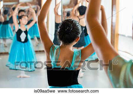 Stock Image - Ballet dancers practising in studio. Fotosearch