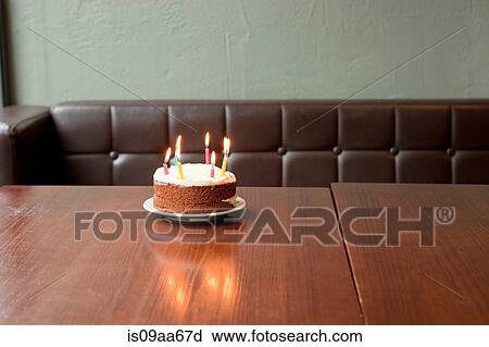 Stock Image - Birthday cake on table in restaurant. Fotosearch