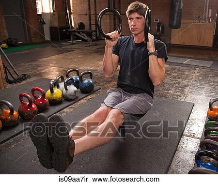 Bodybuilder on gym floor using rings View Large Photo Image Stock Photography - Bodybuilder on gym floor using rings. Fotosearch