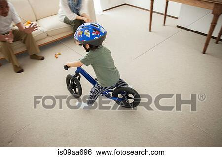 Boy learning to ride bicycle, high angle View Large Photo Image Stock Photograph - Boy learning to ride bicycle, high angle. Fotosearch