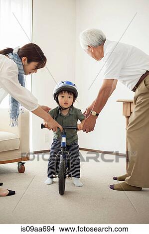 Boy learning to ride bicycle View Large Photo Image Picture - Boy learning to ride bicycle. Fotosearch