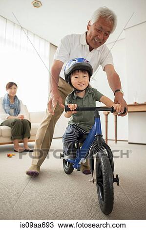 Boy learning to ride bicycle View Large Photo Image Stock Image - Boy learning to ride bicycle. Fotosearch
