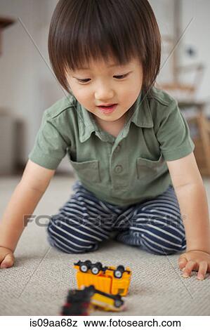 Boy playing with toy car, portrait View Large Photo Image Stock Photo - Boy playing with toy car, portrait. Fotosearch