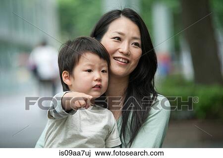 Boy pointing with mother, smiling View Large Photo Image Stock Image - Boy pointing with mother, smiling. Fotosearch