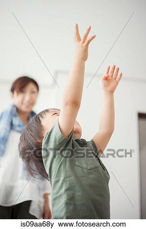 Boy reaching with arms up View Large Photo Image Stock Photo - Boy reaching with arms up. Fotosearch